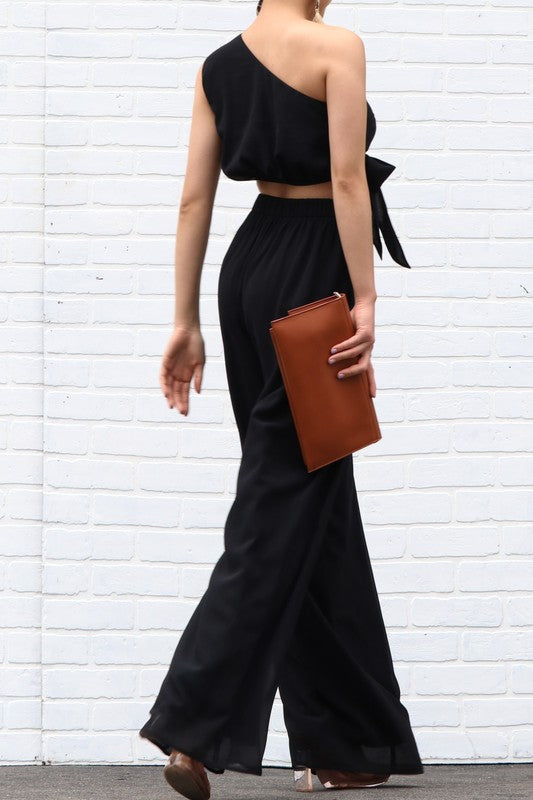 Woven and pleated one shoulder pant set in black with flare pants and side pockets. Scarlette The Label, an online fashion boutique for women.